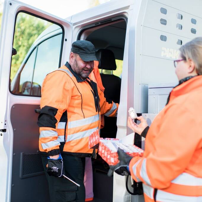 A snapshot of the work at hand. A man and a woman in a working situation with their attention vests on